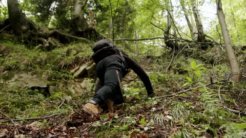 Young man climbing on a difficult trail in the mountains 4K slow-motion. Stock Footage 234552971