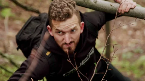 Young man climbing on a difficult trail in the mountains 4K slow-motion. Stock-Footage 234553549