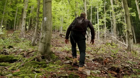 Young man climbing on a difficult trail in the mountains 4K slow-motion. Stock Footage 234554660