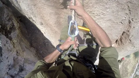 Young man climbing on a rock in a Cave. Climbing equipment. Stock Footage 139466073