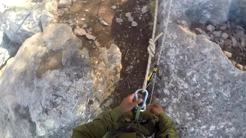 Young man climbing on a rock in a Cave. Climbing equipment. Video stock 139466402