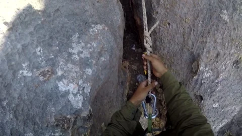 Young man climbing on a rock in a Cave. Climbing equipment. Stock Footage 139466537