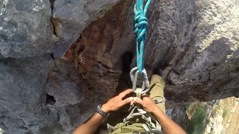 Young man climbing on a rock in a Cave. Climbing equipment. Stock Footage 139466715