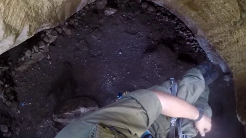 Young man climbing on a rock in a Cave. Climbing equipment. Stock Footage 139466896
