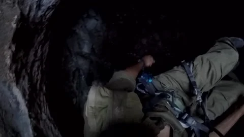 Young man climbing on a rock in a Cave. Climbing equipment. Stock Footage 139467065