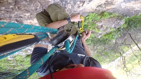 Young man climbing on a rock in a Cave. Climbing equipment. Stock Footage 139467301
