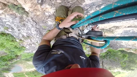 Young man climbing on a rock in a Cave. Climbing equipment. Stock Footage 139467340