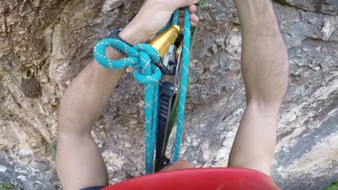 Young man climbing on a rock in a Cave. Climbing equipment. Stock Footage 139467475