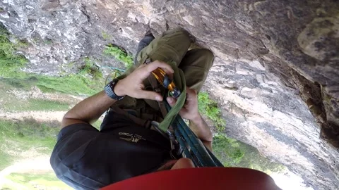 Young man climbing on a rock in a Cave. Climbing equipment. Stock Footage 139467533