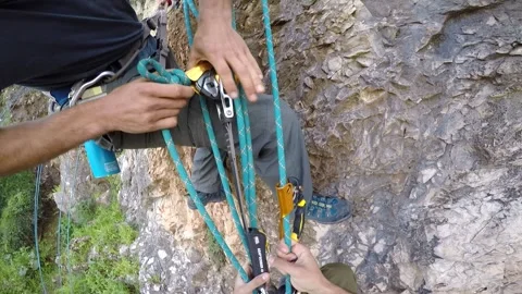 Young man climbing on a rock in a Cave. Climbing equipment. Stock Footage 139467729