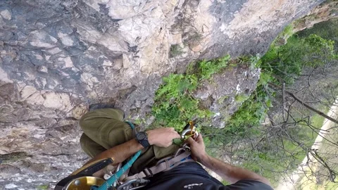 Young man climbing on a rock in a Cave. Climbing equipment. Stock Footage 139467857