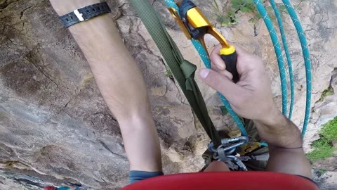 Young man climbing on a rock in a Cave. Climbing equipment. Stock Footage 139468287