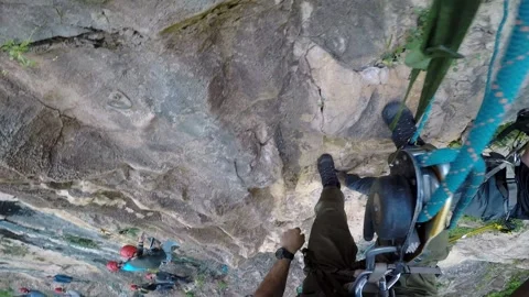 Young man climbing on a rock in a Cave. Climbing equipment. Stock Footage 139468395