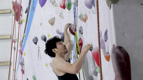 Young Man Climbing A Rock Wall Video stock 236307109