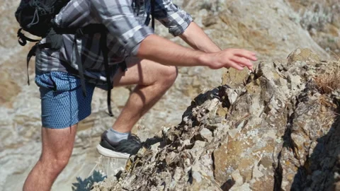 Young man climbing to the top of mountain. Stock Footage 137407682