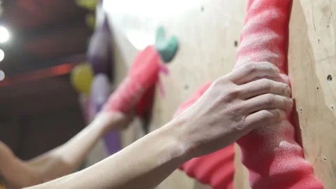 A young man climbs the artificial surface of a climbing wall. Stock Footage 235028185