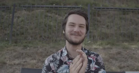 Young man close up, clapping his hands, twice, second time with passion Stock Footage 136898968