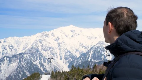 Young man closeup on mountain top in Shinhotaka Ropeway in Japan park Stock Footage 107942692