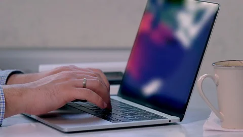 Young man closing down his laptop as he finishes Stock Footage 125898723