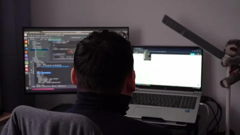 Young man coding on computer at work desk, programmer working late, IT 動画素材 326002921