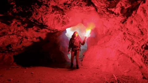 Young man coming in cave Stock Footage 245098523