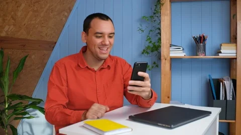 A young man communicates via video link via phone with friends Stock Footage 148228185