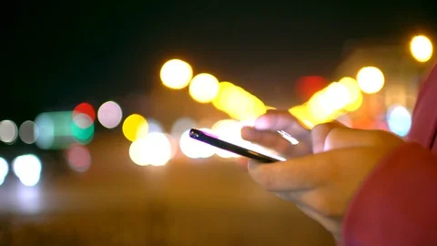A young man is commuting to work while browsing his cellphone on a busy urban Stock Footage 88851690
