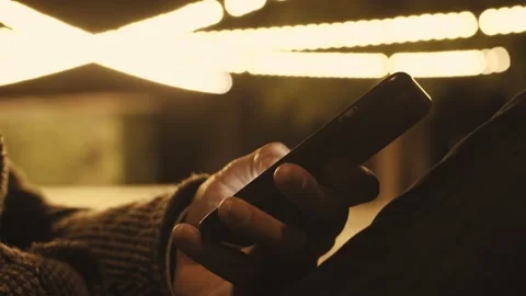 A young man is commuting to work while browsing his cellphone on a busy urban Stock Footage 156087569