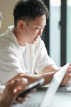 Young man concentrates on tablet with focused expression Stock Photos
