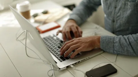 Young man concentrating while working on his laptop. 스톡 동영상 88405571
