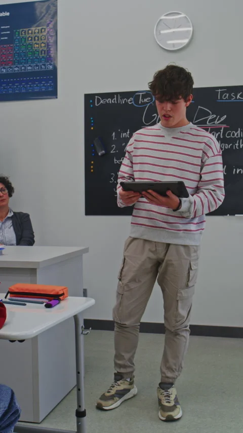 Young Man Confidently Delivers Presentation Using Digital Tablet in Modern Stock Footage 321000397