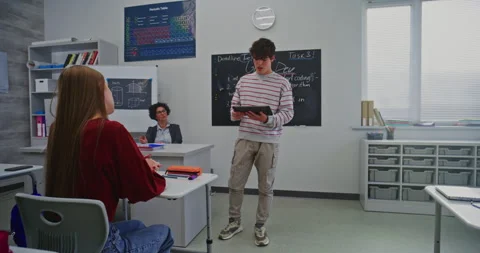 Young Man Confidently Delivers Presentation Using Digital Tablet in Modern Stock Footage 321002487