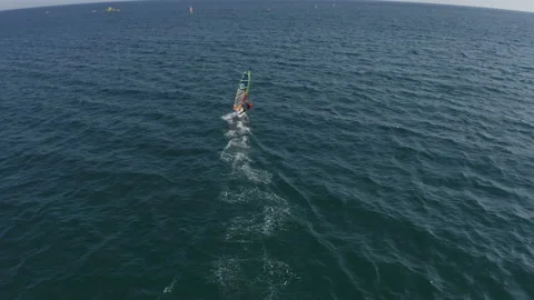 A young man is confidently engaged in Windsurfing Stock Footage 146245313