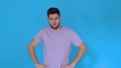 Young man is confused and doesn't understand isolated on blue background Stock Footage 123947716