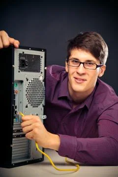 Young Man Connecting A Network Cable Stock Photos