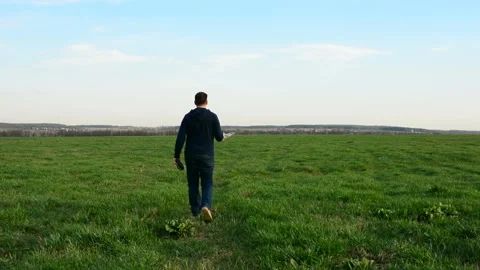 Young man controling drone in field at sunset. Video stock 89449230