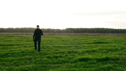 Young man controling drone in field at sunset. Stock Footage 89449673