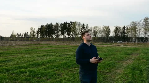Young man controling drone in field at sunset. Stock Footage 89451880