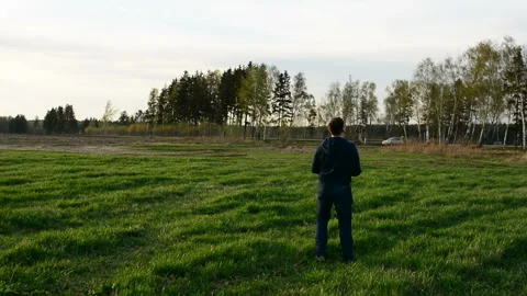 Young man controling drone in field at sunset. Stock Footage 89452641