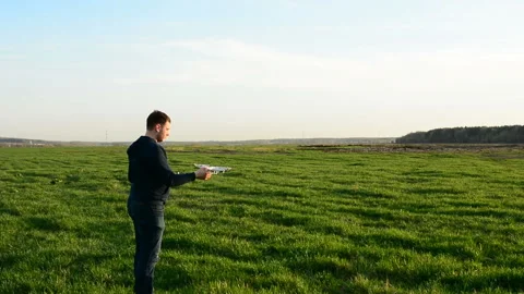 Young man controling drone in field at sunset. Stock Footage 89453657