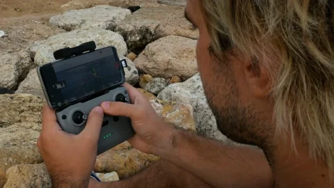 Young man controlling drone by rc controller Stock Footage 156334929