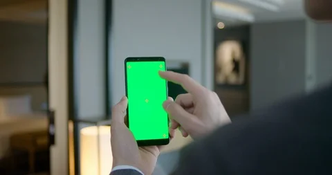 Young man controlling light by mobile app on smartphone,4K Stock Footage 118237328