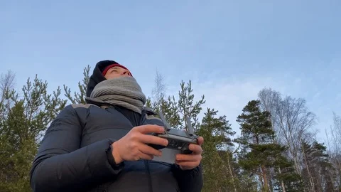Young man controls a drone through a remote control Stock-Footage 122910488
