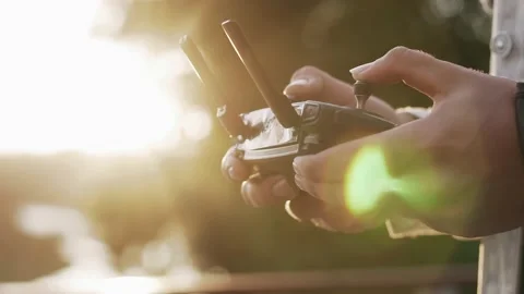A young man controls a drone using a remote control in his hand Stock Footage 157430824