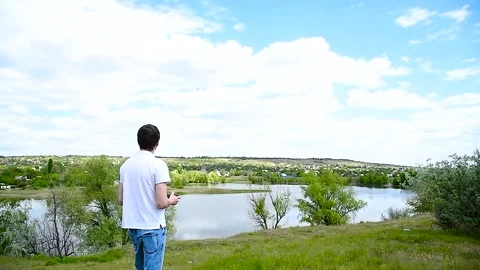 Young man controls a drone using a remote control Stock Footage 310045195