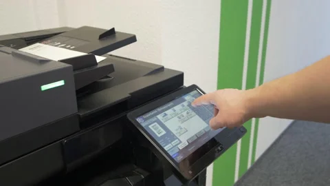 Young man copies documents on a copying system in office Stock-Footage 170748629
