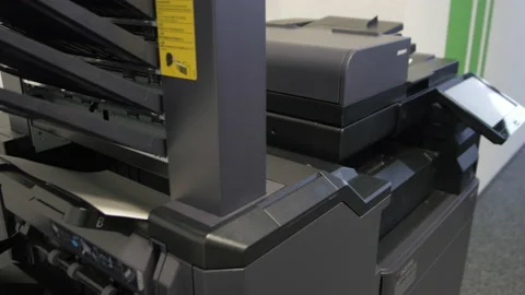 Young man copies documents on a copying system in office Stock Footage 170751637
