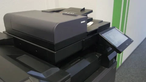 Young man copies documents on a copying system in office Stock-Footage 170757680