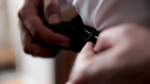 The young man corrects a belt on trousers. Stock Footage 101176428