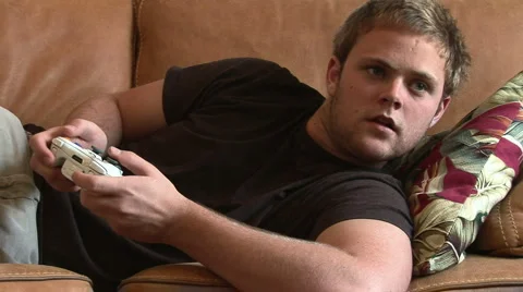 Young man on couch playing video game Video stock 935353